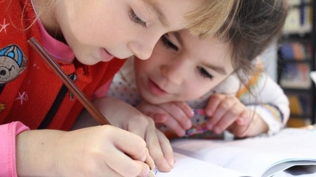 Kids doing homework School board attaches non-compete clause to building sale